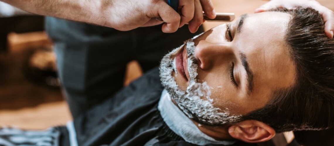 barber-shaving-bearded-man-with-shaving-cream-on-f-2022-12-16-16-52-31-utc (1)