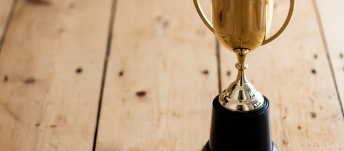 gold-winners-trophy-on-a-wooden-background-2022-11-02-18-21-33-utc-1