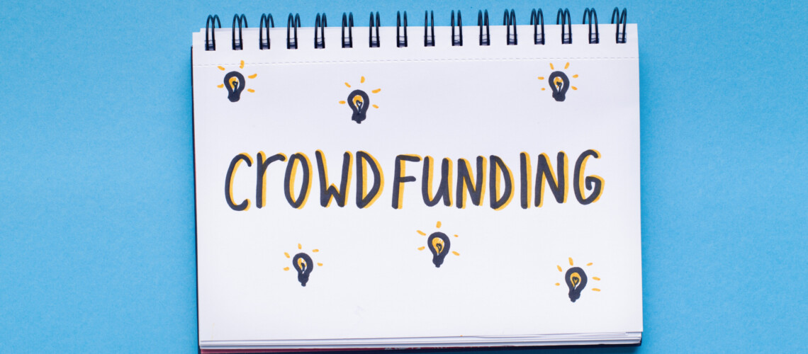 Crowdfunding concept. Handwriting red text in notepad on blue background, panorama, copy space