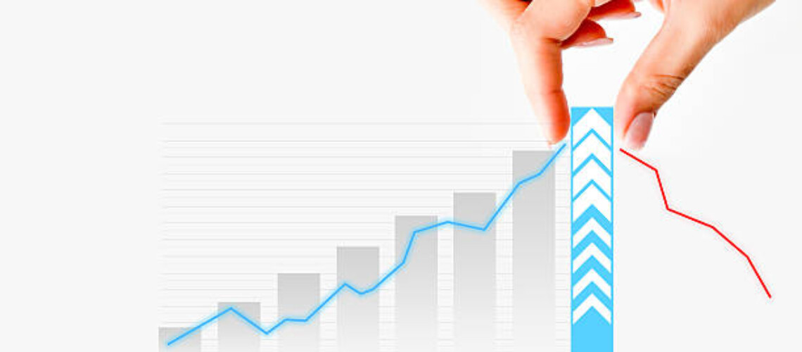 Human hand pulling graph bar suggesting increase of sales or business