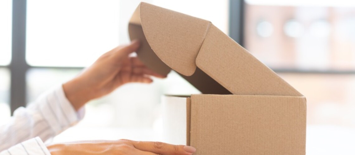 lady-opening-box-with-new-parcel-close-up-2021-08-28-23-19-07-utc-1