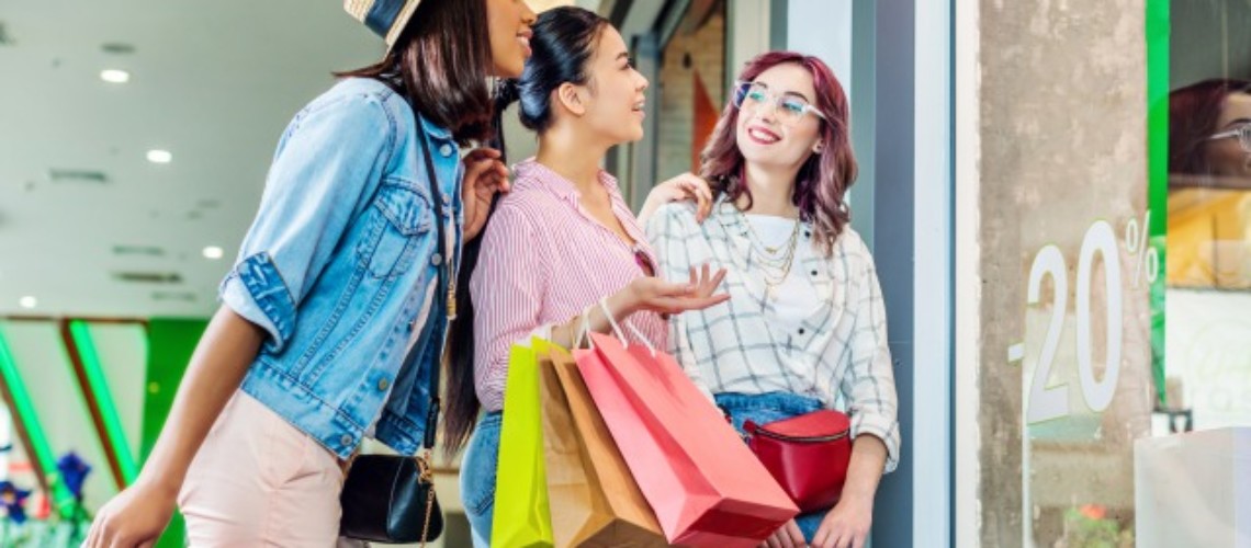 multicultural-hipster-girls-with-shopping-bags-in-ARKVMFL-1-1