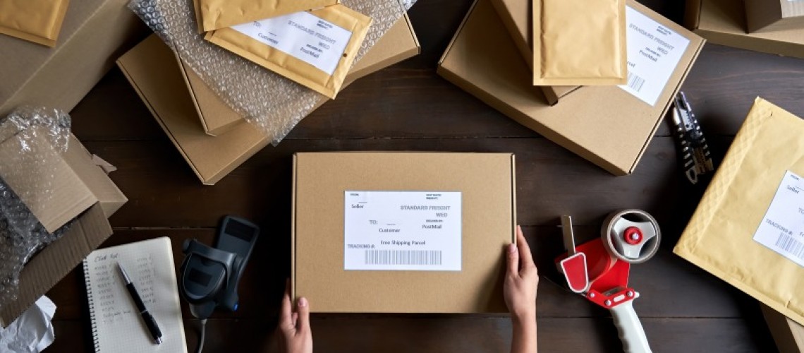 top-view-of-female-warehouse-worker-packing-shippi-2023-11-27-05-25-58-utc-1