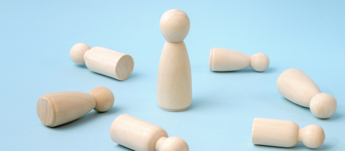 Winner eliminating competitors, winning, victory, success and surviving concept. Wooden figurines. One against the others. Last man standing. Against all odds. Stand out of competitors